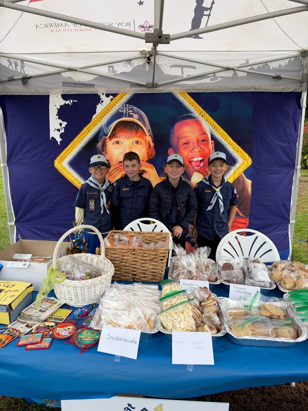 Cub Scouts at a bake sale table at Bauer Park
