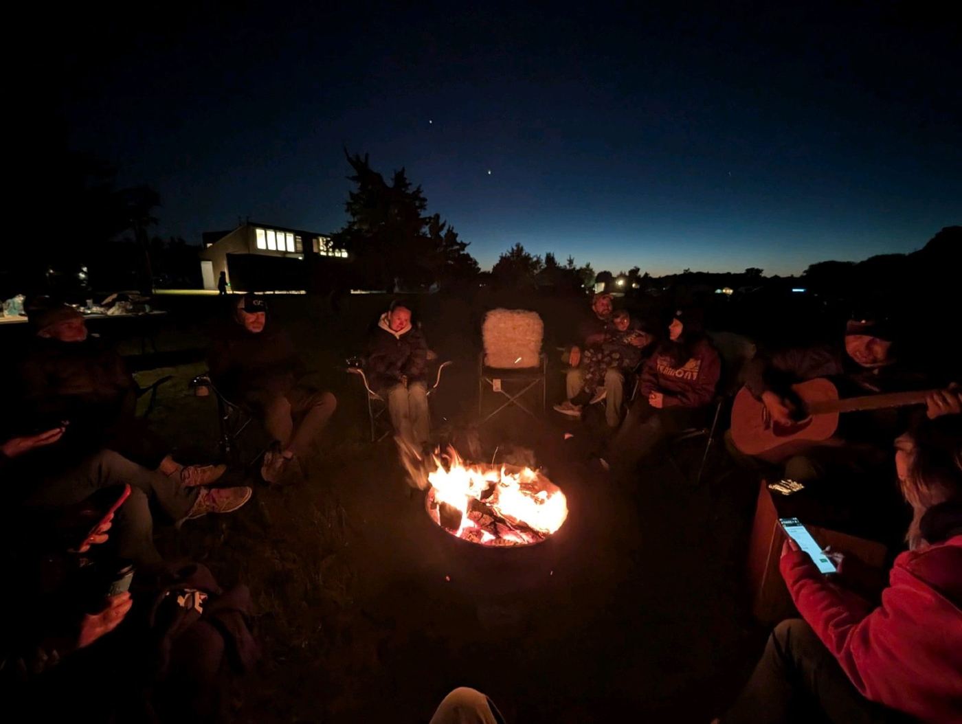 Families around a campfire at dusk