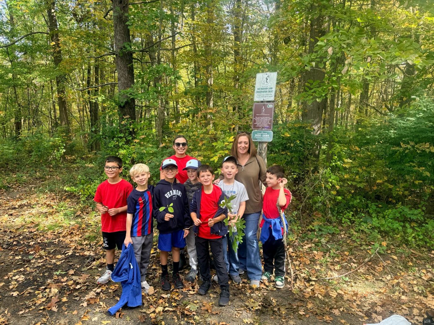 Bear den Scouts and parents at a trail sign