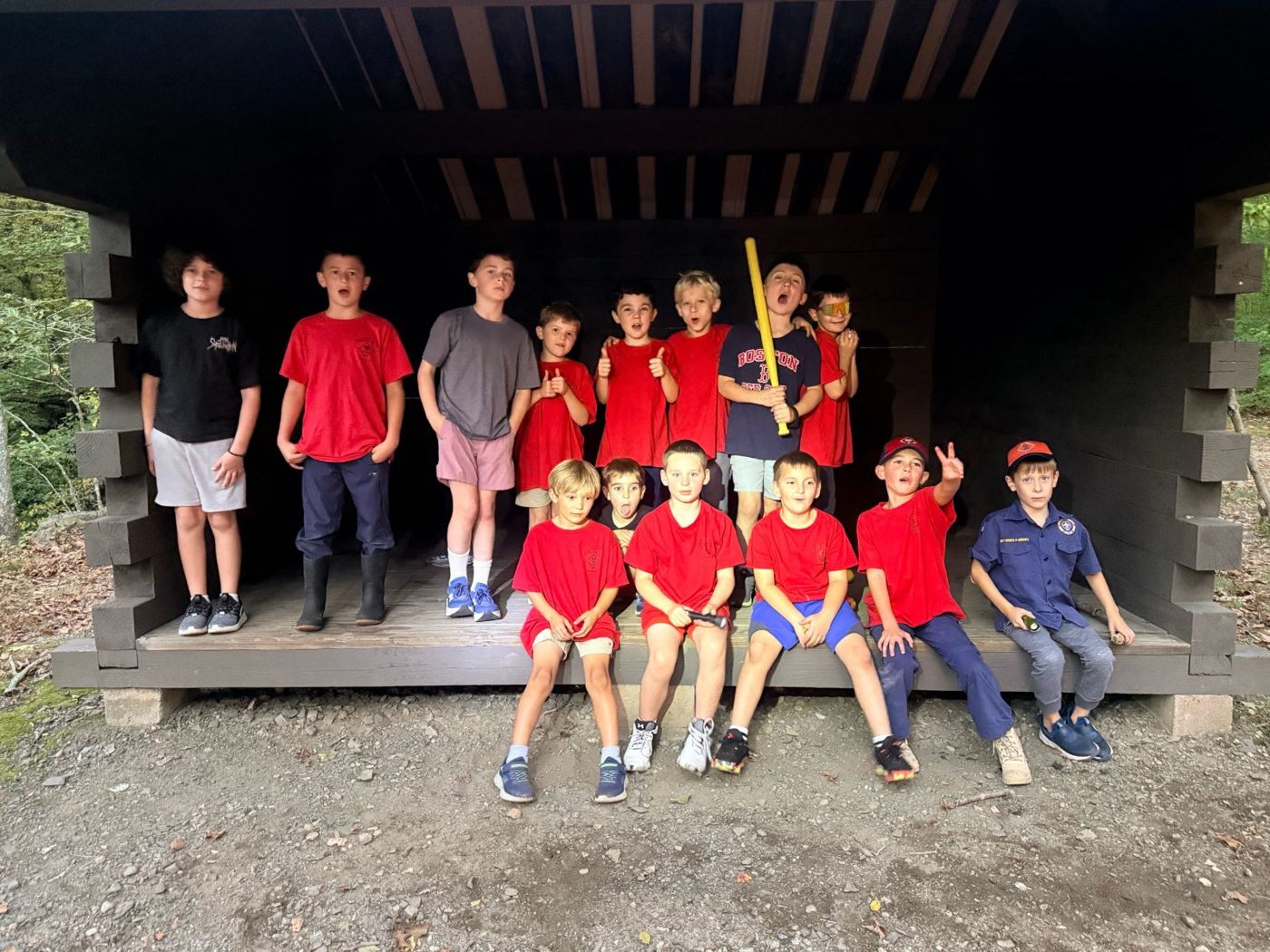 Cub Scouts lined up in a lean-to shelter at the fall campout